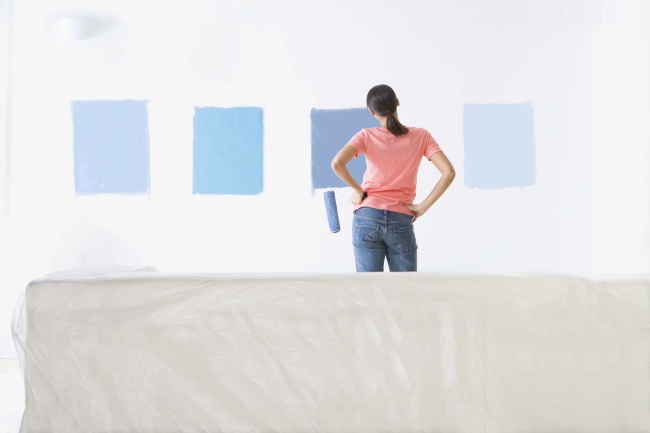 Woman painting wall