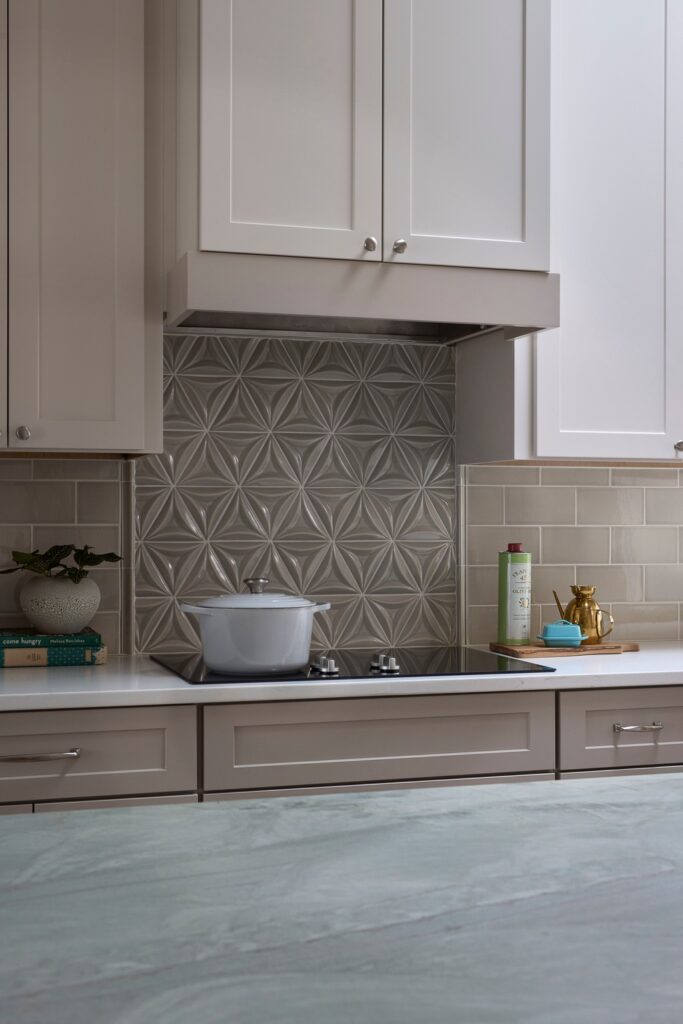 After kitchen renovation - updated induction cooktop and hidden vent hood, Aqua Quartzite countertops